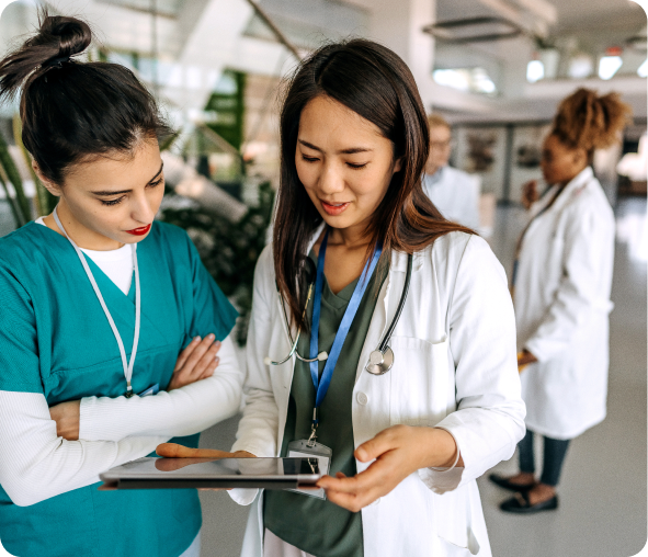 Medical professionals reviewing patient information on tablet.